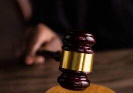 brown and gold gavel on brown wooden table