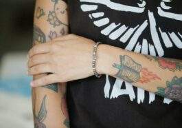 person with tattoos on arms